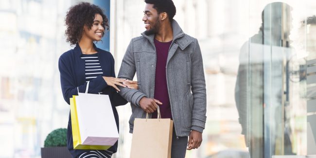 Happy black couple in love making shopping on weekend